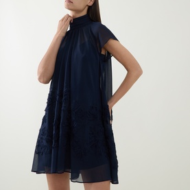 Model wearing Jonathan Simkhai Aviel Floral Appliqu&eacute; Mini Dress in Midnight, with gathered high neck, cap sleeves and soutache embroidered detailing
