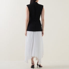 Model wearing Jonathan Simkhai Black Multi dress, back view showing sleeveless black bodice and white asymmetric pleated skirt, with black heeled