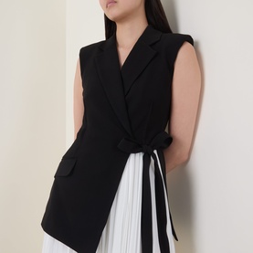 Model wearing Jonathan Simkhai Black Multi dress with sleeveless blazer-style front and pleated white side panel detail
