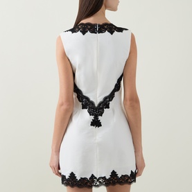 Model wearing Jonathan Simkhai Dress in Ivory Multi, back view, sleeveless with black lace trim at collar, V-back and hem.