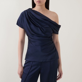 Model wearing Jonathan Simkhai midnight blue one-shoulder draped acetate top, styled with matching wide-leg trousers.