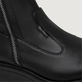 Marco Moreo black leather ankle boot close-up showing silver side zip detail and branded logo tab