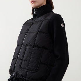 Model wearing Moncler black quilted cardigan with knit collar, sleeves, and Moncler arm badge detail