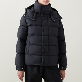 Model wearing Moncler black quilted down puffer jacket with detachable hood and press-stud collar detail