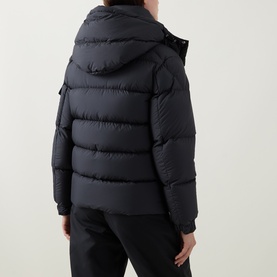 Model wearing Moncler black quilted hooded puffer jacket, rear view, styled with black trousers