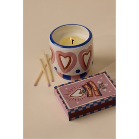 Paddywax A Dopo Hearts Ceramic Candle in Rosewood Vanilla, pink heart-patterned vessel with yellow wax, shown with matchbox and loose matches