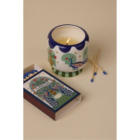 Paddywax A Dopo Peacock Ceramic Candle in Misted Lime, illustrated ceramic vessel with peacock motif, shown with matching box of blue-tipped matches