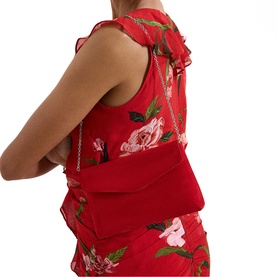 Model carrying Phase Eight red structured shoulder bag with silver chain strap, styled with red floral print dress.