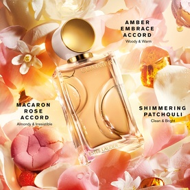 Est&eacute;e Lauder EDP fragrance bottle surrounded by florals with Amber Embrace, Macaron Rose and Shimmering Patchouli accord notes