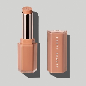 Fenty Beauty Gloss Bomb Stix lip gloss in Birthday Suit, 3.6g, shown open and capped in nude-pink rose gold packaging