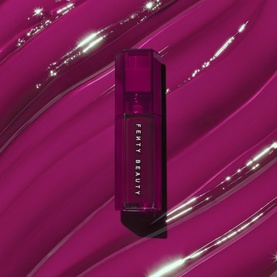 Fenty Beauty Gloss Bomb Burst Colour-Intensifying Lip Luminiser in Pink Blink, deep berry lip gloss tube on glossy magenta swatch background