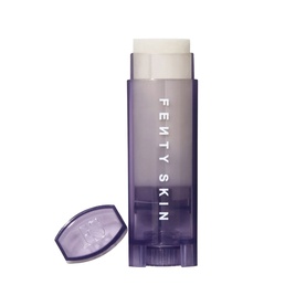 Fenty Skin lip care balm stick in lilac semi-transparent packaging with matching cap, shown open to reveal white balm tip