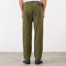 Model wearing Gramicci Gadget Belted Trousers in olive, rear view showing cargo pockets, adjustable belt and straight-cut leg, styled with black