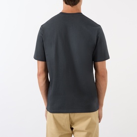 Model wearing Gramicci Ladybug Logo T-Shirt in black, shown from the back, with khaki trousers. Short sleeves, crew neck, straight hem.