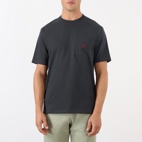 Model wearing Gramicci One Point Chest Pocket T-Shirt in black with small red logo, paired with light khaki trousers.