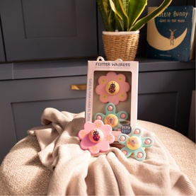 Flutter Whirligig children's spinning toy set in pink and pastel colours with ladybird detail, shown in and out of packaging