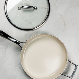 Prochef Signature 26cm Pressed Ceramic Saut&eacute; Pan in Sage Green with cream ceramic interior, shown with glass lid on marble surface.