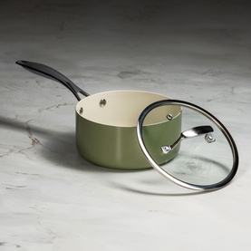 Prochef Signature 20cm Ceramic Pressed Saucepan in sage green with cream interior, glass lid and black handle, on marble surface