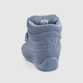Puma high-top suede sneaker in gray sky, rear view showing padded ankle collar, hook-and-loop strap, and patterned rubber sole.