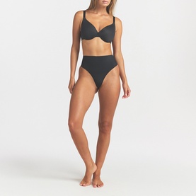 Model wearing Skims Full Cup Bra in black, styled with matching high-waist black bikini briefs