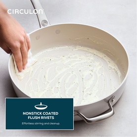 Circulon Halo LaserDefense Ceramic Saut&eacute; Pan 30cm in white, hand wiping cream-coloured nonstick interior, stainless steel handles visible.