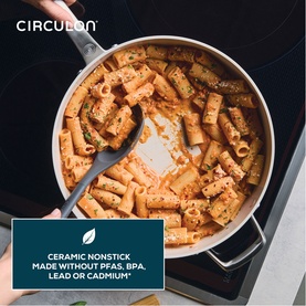 Circulon Halo LaserDefense&trade; Ceramic Saut&eacute; Pan 30cm in white, shown on induction hob filled with tomato pasta, being stirred with spatula.