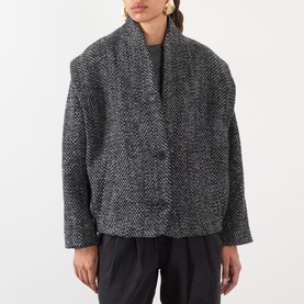Model wearing Isabel Marant Etoile sand wool-blend tweed blazer with oversized silhouette, styled with black wide-leg trousers.
