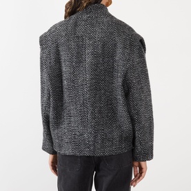 Model wearing Isabel Marant Etoile Sand wool-blend tweed blazer, rear view, styled with dark grey trousers.