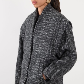 Model wearing Isabel Marant Etoile sand wool blazer, shown in close-up detail highlighting chunky herringbone texture and relaxed fit