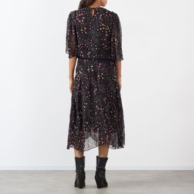 Model wearing Isabel Marant Etoile Frida Abstract Print Dress in black with floral print, rear keyhole, flutter sleeves, midi length, styled with