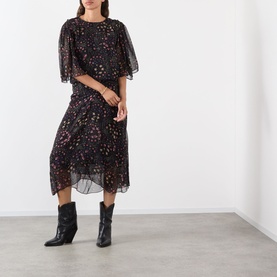 Model wearing Isabel Marant Etoile Frida Abstract Print Dress in black, flutter sleeves, midi length floral overlay, styled with black ankle boots