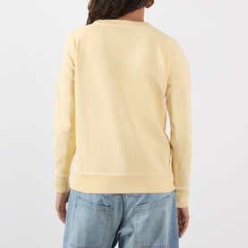 Model wearing Isabel Marant Etoile Millyny Logo Sweatshirt in light yellow, back view, with light blue jeans.