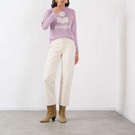 Model wearing Isabel Marant Etoile Millyny Logo Sweatshirt in Rosewood/Ecru, styled with cream wide-leg trousers and tan ankle boots.