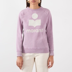 Model wearing Isabel Marant Etoile Millyny Logo Sweatshirt in Rosewood/Ecru, round neck, raglan sleeves, styled with cream trousers.