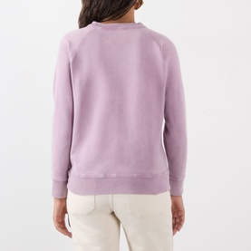 Model wearing Isabel Marant Etoile Millyny Logo Sweatshirt in Rosewood, rear view, raglan sleeves, ribbed trims, styled with cream trousers.
