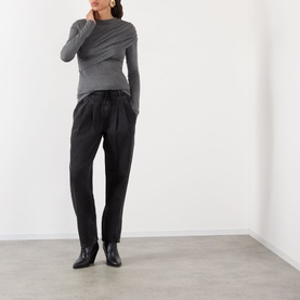 Model wearing Isabel Marant Etoile grey viscose top with draped neckline, styled with black tapered trousers and ankle boots