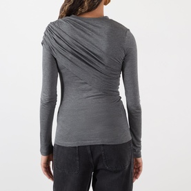 Model wearing Isabel Marant Etoile grey long-sleeve top with draped ruched detail across the back, styled with dark wide-leg trousers.