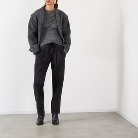 Model wearing Isabel Marant Etoile grey viscose top, styled with dark knit cardigan, black tapered trousers and black ankle boots.