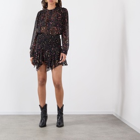 Model wearing Isabel Marant Etoile Florine Abstract Print Blouse in black/ecru, styled with a mini skirt and black cowboy boots.