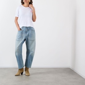 Model wearing Isabel Marant Etoile Koldia Logo T-Shirt in White/Pink, styled with light blue wide-leg jeans and tan ankle boots.