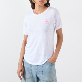 Model wearing Isabel Marant Etoile Koldia Logo T-Shirt in white with pink chest logo, turn-up cuffs and curved hem, styled with light blue jeans.