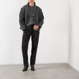 Model wearing Isabel Marant Etoile faded black cotton trousers with a grey knit cardigan and black ankle boots.