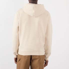 Model wearing Jacquemus beige cotton hoodie, back view, styled with tan cargo trousers.