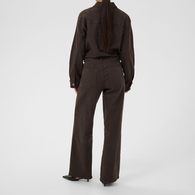 Model wearing Kaffe Coffee Bean wide-leg trousers, styled with a matching dark brown shirt, rear view