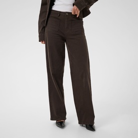 Model wearing Kaffe Coffee Bean wide-leg trousers with pressed front crease, styled with black heeled mules and a brown jacket.