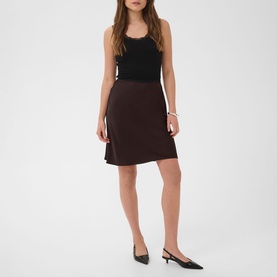 Model wearing Kaffe Coffee Bean mini skirt with black sleeveless top and black pointed kitten heel mules.