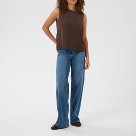Model wearing Kaffe Coffee Bean sleeveless top with wide-leg blue jeans and brown loafers