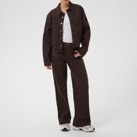 Model wearing Kaffe Coffee Bean wide-leg trousers, styled with matching jacket and white top, paired with white trainers.