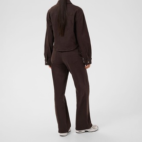 Model wearing Kaffe Coffee Bean knit wide-leg trousers, styled with matching zip-up top and white trainers, rear view.