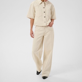 Model wearing Kaffe off white washed wide-leg trousers, styled with a matching short-sleeve button-up jacket and black heeled mules